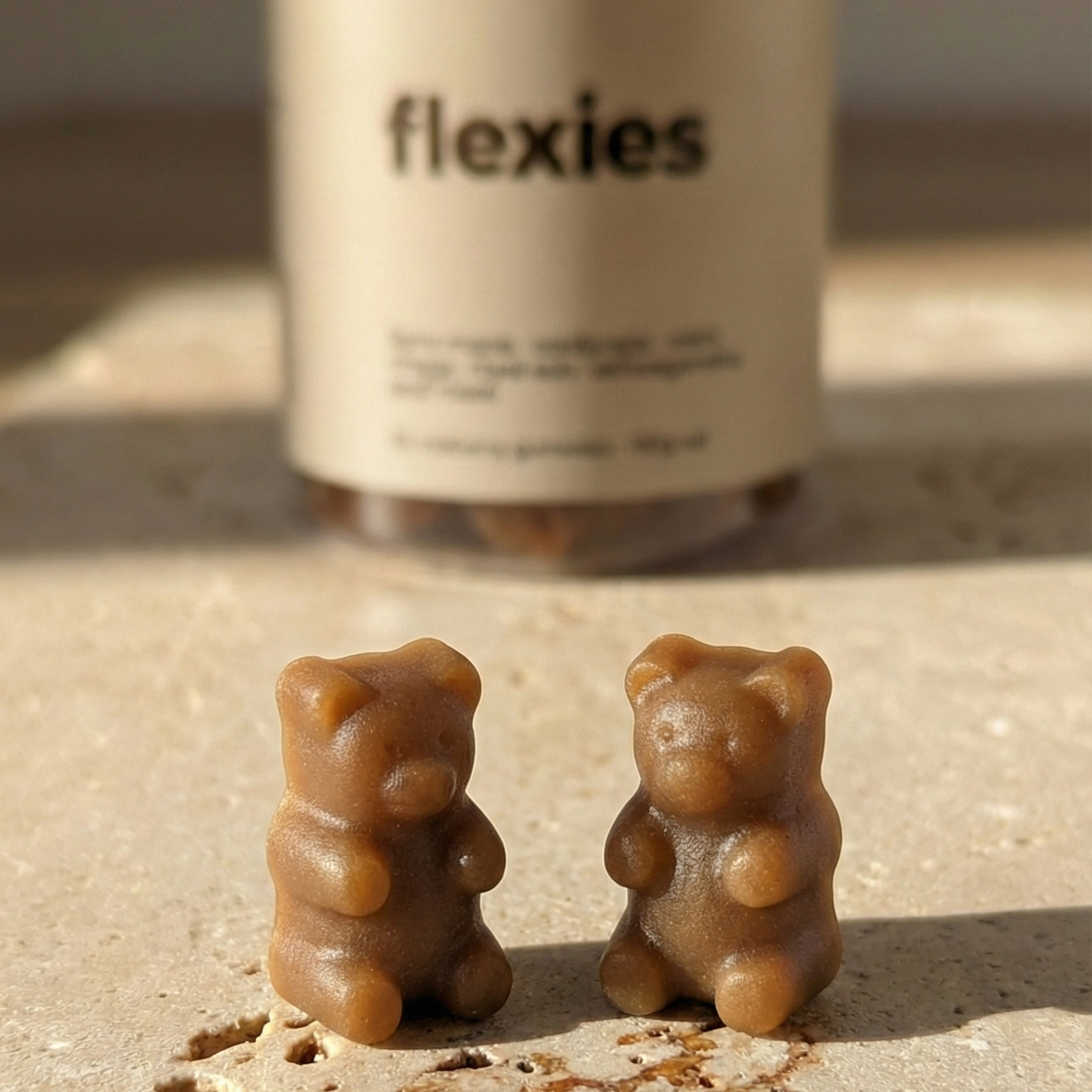 Close-up of brown mushroom gummies with bottle in background