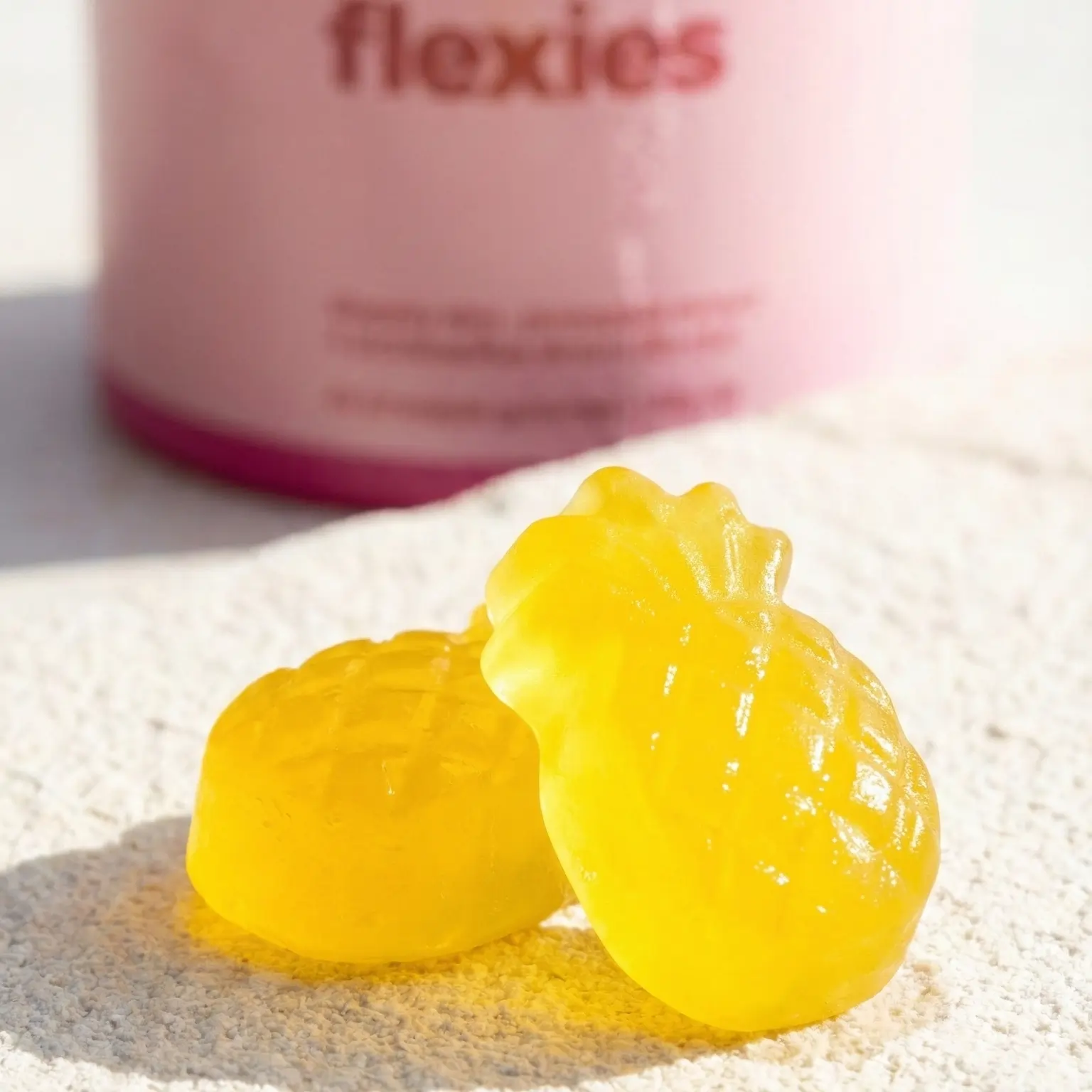 Close-up of yellow probiotic gummies with bottle in background